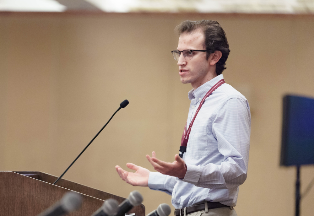 Conrad Kramer speaking at a Podium