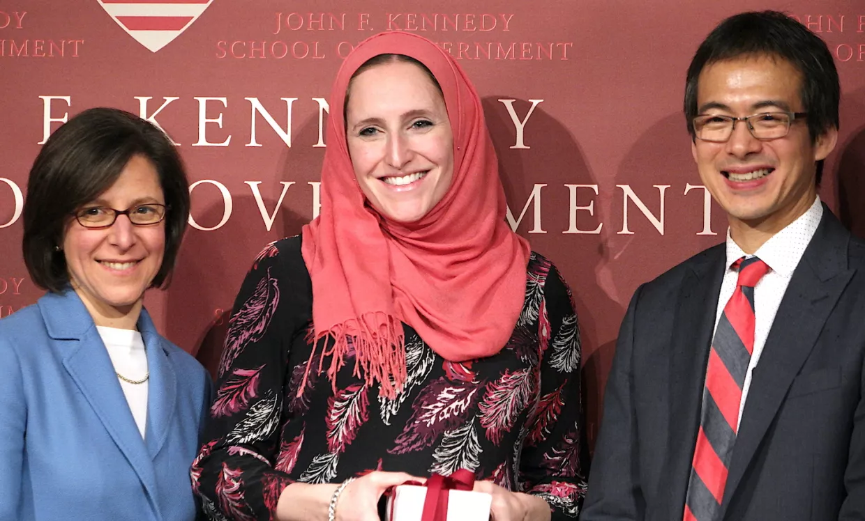 Julia Martin (center) receives a Harvard Kennedy School anniversary award.