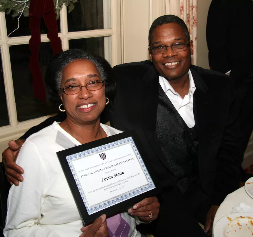 Lovita Strain, sitting next to her husband Marcell, shows off her Peggy Scannell Award for Excellence.