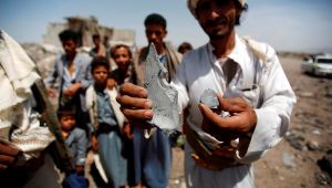 A man shows fragments of a bomb from the rubble of houses destroyed by a Saudi-led airstrike on the outskirts of Sanaa, Yemen, Wednesday, June 3, 2015.