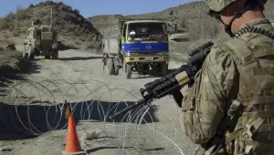 In this Dec. 1, 2011, file photo, a U.S. soldier with Apache Company of Task Force 3-66 Armor, out of Grafenwoehr, Germany, stands guard at a police checkpoint at Gulruddin pass in Sar Hawza district of Paktika province, south of Kabul, Afghanistan.
