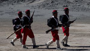 Bolivian soldiers, dressed in costumes to look like Chilean soldiers, walk during the reenactment of the battle of "Canchas Blancas," which took place in 1879 during the Pacific War that Bolivia lost to Chile. Wednesday, March 28, 2018.