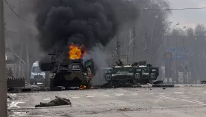 Photo of a Russian armored personnel carrier burning amid damaged and abandoned light utility vehicles after fighting in Kharkiv, Ukraine, Sunday, Feb. 27, 2022. The city authorities said that Ukrainian forces engaged in fighting with Russian troops that entered the country's second-largest city on Sunday. 