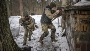 People practice combat skills in urban areas during a training course for national resistance of the Municipal Guard near Kyiv, Ukraine, on Jan. 19, 2024.