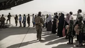 In this image provided by the U.S. Marine Corps, evacuees wait to board a Boeing C-17 Globemaster III during an evacuation at Hamid Karzai International Airport in Kabul, Afghanistan, Monday, Aug. 30. 2021. 