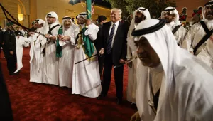 President Donald Trump holds a sword and sways with traditional dancers during a welcome ceremony at Murabba Palace in Riyadh