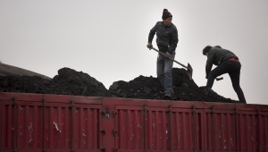 Workers shovel coal atop a trailer truck at a coal mine near Ordos in northern China’s Inner Mongolia Autonomous Region.