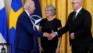 President Joe Biden shakes hands with Mikko Hautala, Finland's ambassador to the U.S., as he speaks with Hautala and Karin Olofsdotter, Sweden's ambassador to the U.S.