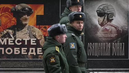 A military patrol passes by a street exhibition of military posters named 'Together to Victory' dedicated to Russian army in St. Petersburg, Russia, Monday, Feb. 24, 2025.