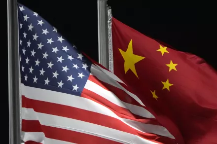China US Flags - FILE - The American and Chinese flags wave at Genting Snow Park ahead of the 2022 Winter Olympics, Feb. 2, 2022, in Zhangjiakou, China