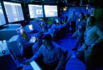 In this May 12, 1999, U.S. Navy handout photo, air traffic controllers monitor the radar screens of the Air Operations Center aboard the USS Theodore Roosevelt aircraft carrier in support of airstrikes against Yugoslavia.