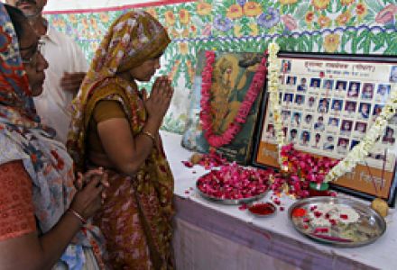 Relatives of the victims of the 2002 Godhra train burning pay homage during a ceremony on the anniversary of the incident in Ahmadabad, India, Feb. 27, 2011. A special court found 31 Muslims guilty of setting fire to a train in which 60 Hindus were killed