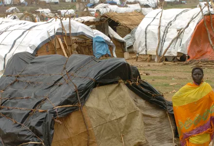 A woman walks with her child in a refugee camp in the western Darfur region of Sudan. This photograph was taken sometime in October of 2004.