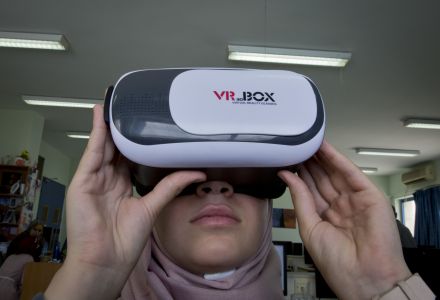 In this Thursday, Aug. 2, 2018 photo, Wassan al-Sayyed,17, uses a 3D glasses headset that is running the team's virtual reality game "Be a Fire Fighter" in the West Bank city of Nablus. For the 11th graders from the Israeli-occupied West Bank, the ticket of admission to the World Pitch Summit signals a particularly dramatic leap because of the limited opportunities at home. 