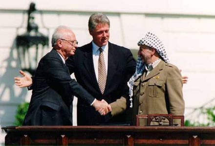 U.S. President Bill Clinton, Israeli Prime Minister Yitzhak Rabin and Palestinian leader Yasser Arafat sign the historic Oslo accord at the White House in September 1993.