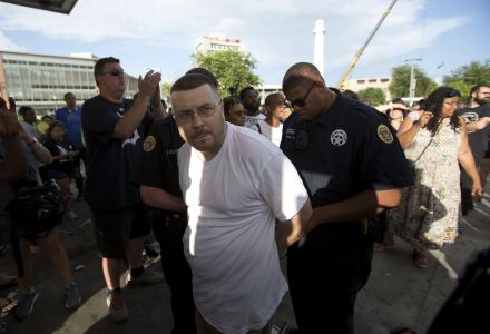 A man is arrested as the statue of Confederate General Robert E. Lee is removed in New Orleans