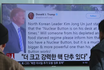 People watch a TV news program showing the tweet of U.S. President Donald Trump while reporting North Korea's nuclear issue