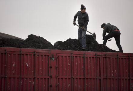 Workers shovel coal atop a trailer truck at a coal mine near Ordos in northern China’s Inner Mongolia Autonomous Region.